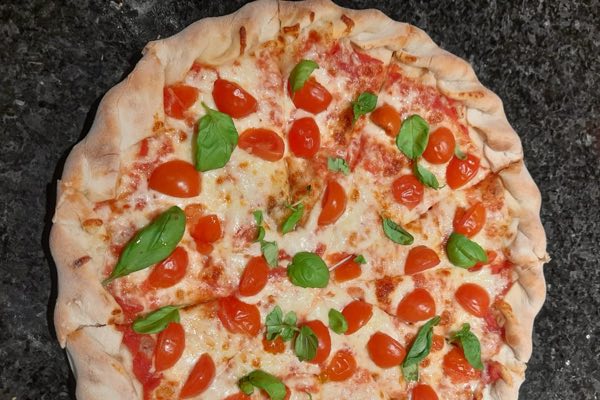 Brazilian margherita with cherry tomatoes and basil on a stuffed crust.