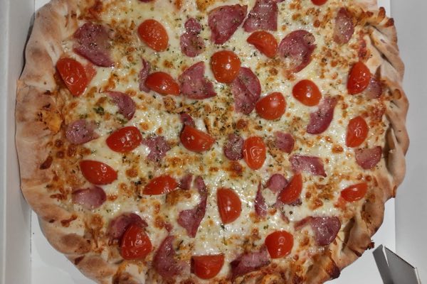 Pepperoni pizza with cherry tomatoes and mozzarella.